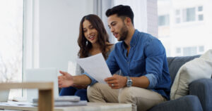 Home, laptop or couple with financial contract, salary or budget for household bills or mortgage. Reading, insurance paperwork or people with financial income for investment info, report and savings