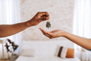Real estate agent giving a person the keys to their new home
